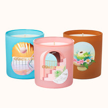 Three colorful candles with decorative lids on a white background