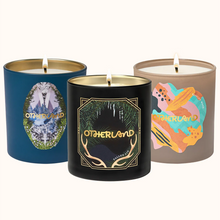 Three candles with 'Otherland' branding on a white background