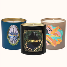Three candles with 'Otherland' branding on a white background