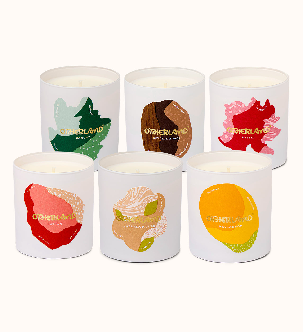 Set of six scented candles with colorful labels on a white background