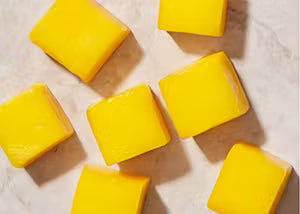 Yellow square-shaped objects on a textured surface