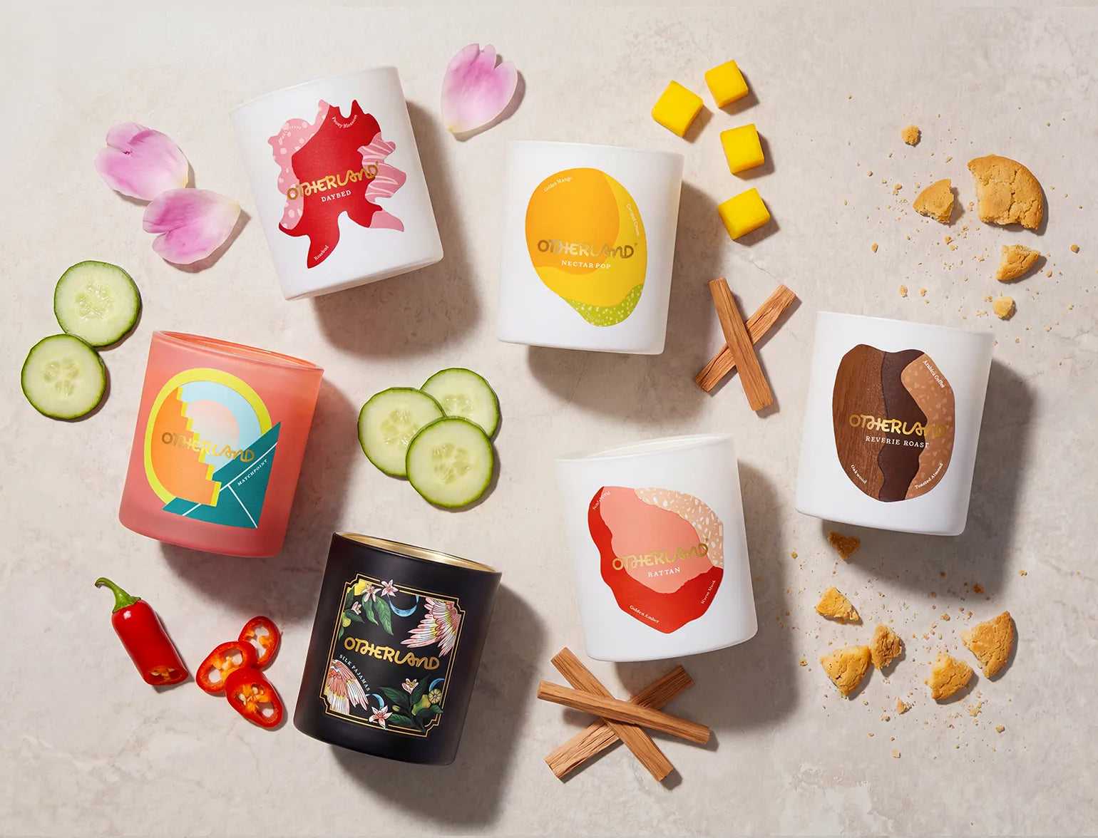 Collection of 'Otherland' candles with various scents on a neutral background