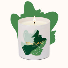 Candle in a container with 'Otherland' branding and leaf design on a white background