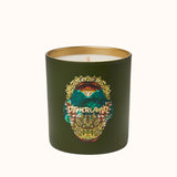 Green candle with a decorative label on a white background