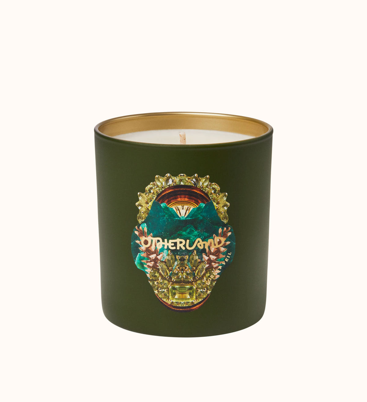 Green candle with a decorative label on a white background