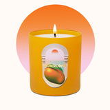 Yellow candle with a label featuring an orange on a gradient background