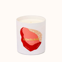 Rattan candle with a red and gold abstract design on a white background