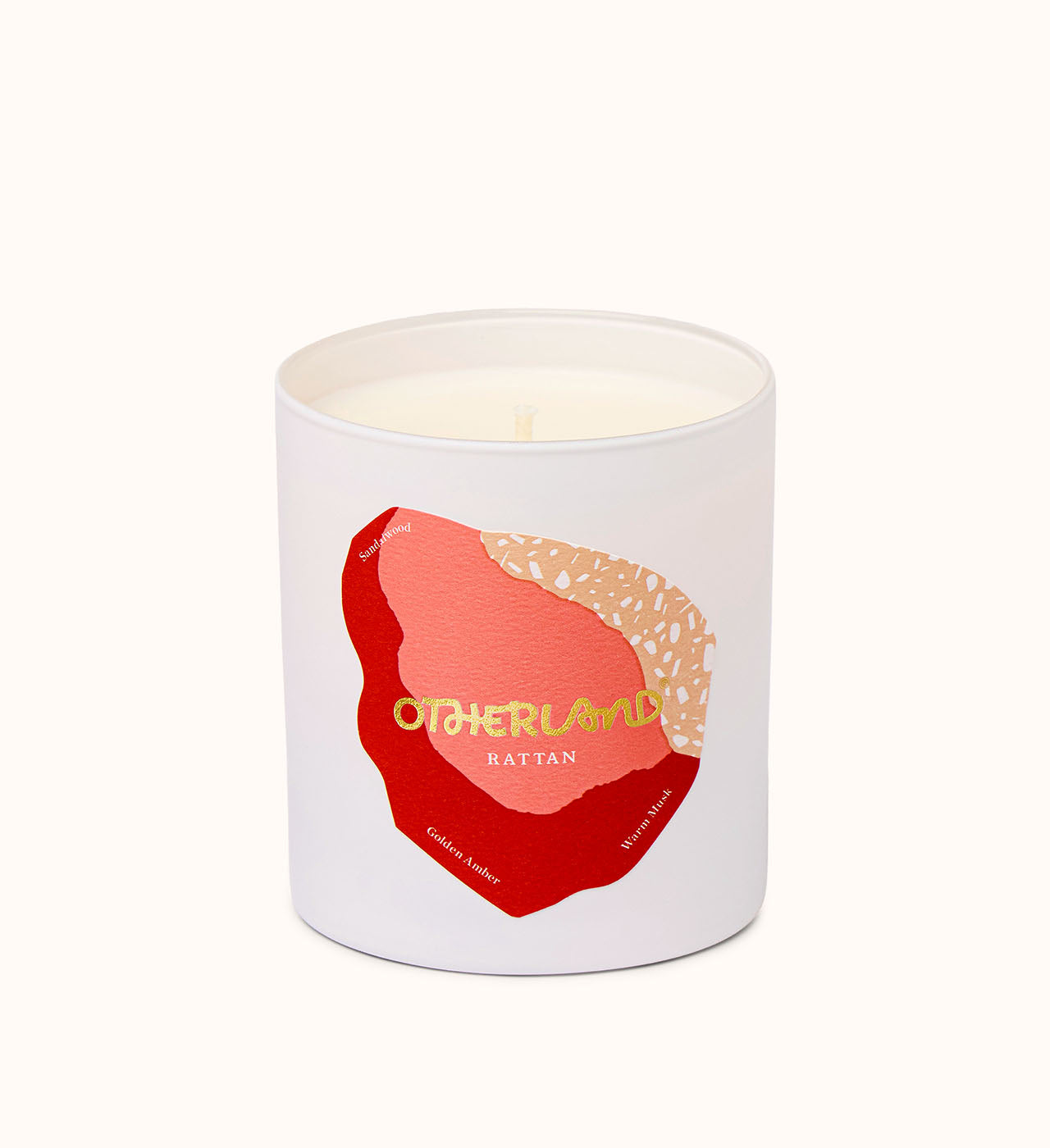 Rattan candle with a red and gold abstract design on a white background