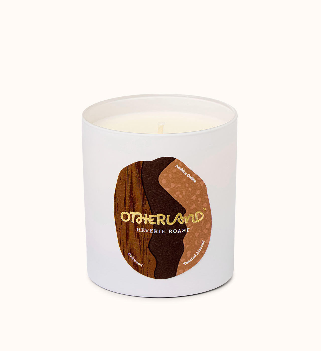 Reverie Roast candle with a brown label featuring 'Otherland' branding on a white background