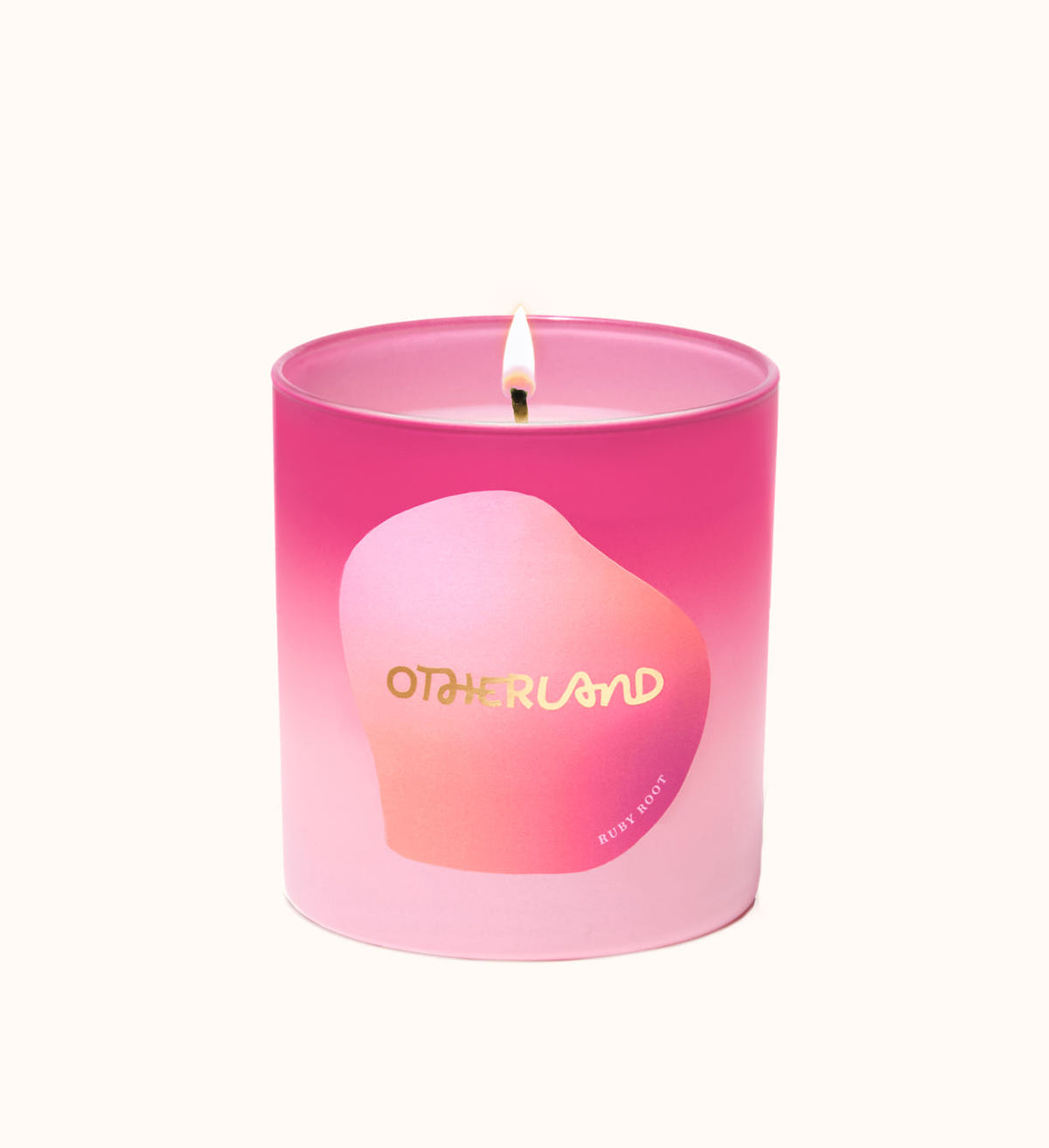 Pink candle with a gradient design and 'Otherland' branding on a white background