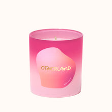 Pink candle with gradient design and 'Otherland' branding on a white background