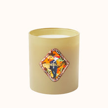 Beige candle with a decorative label on a white background