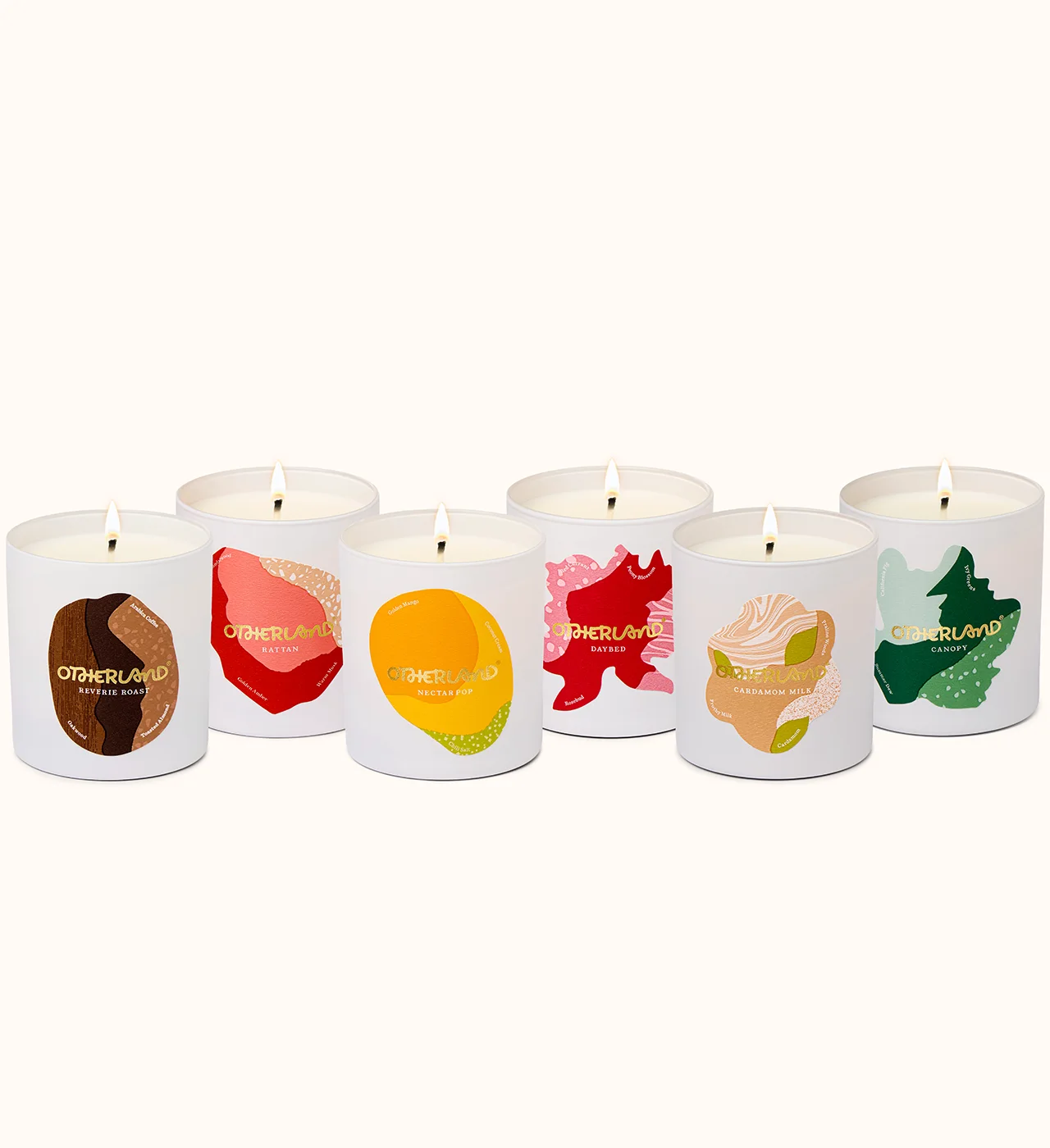 Set of six candles with colorful labels on a white background