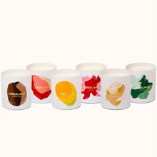 Set of six candles with colorful labels on a white background