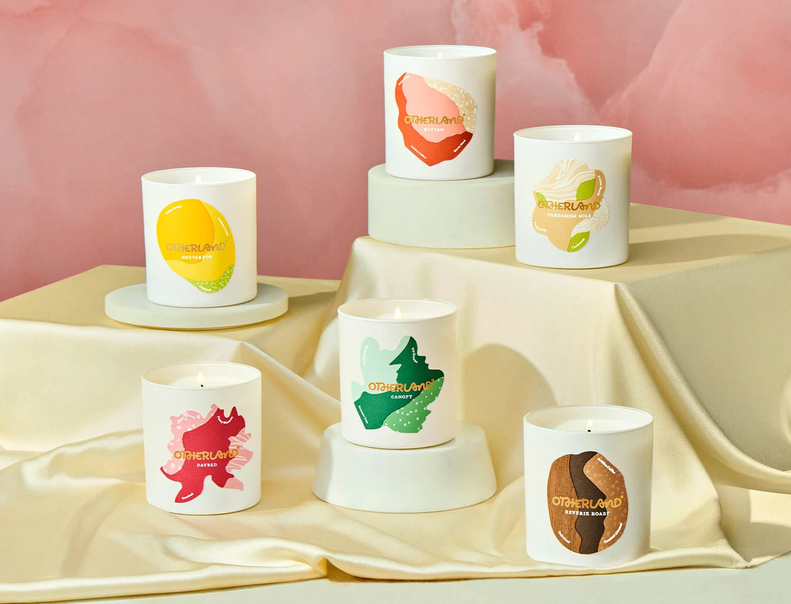 Set of candles with colorful designs on a light fabric background