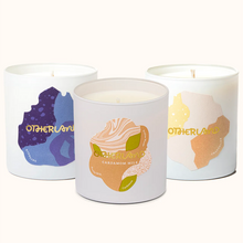 Three candles with colorful labels on a white background