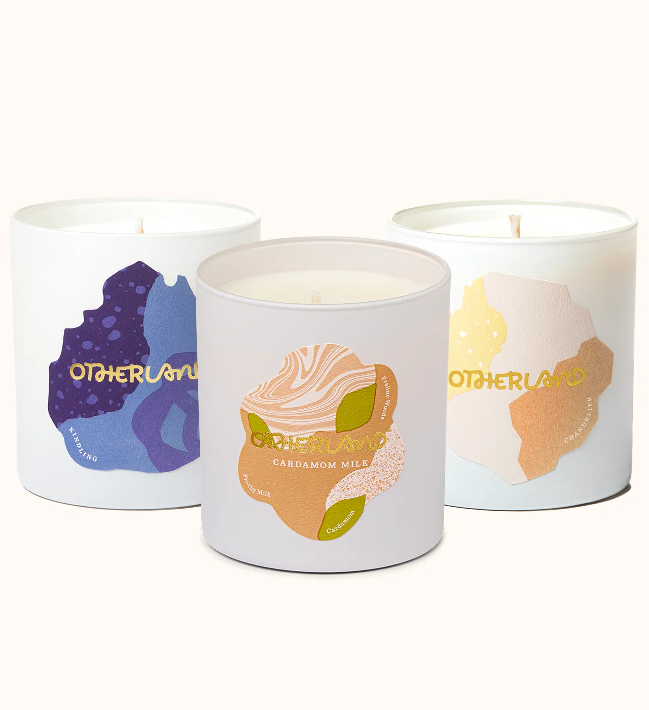 Three candles with colorful labels on a white background
