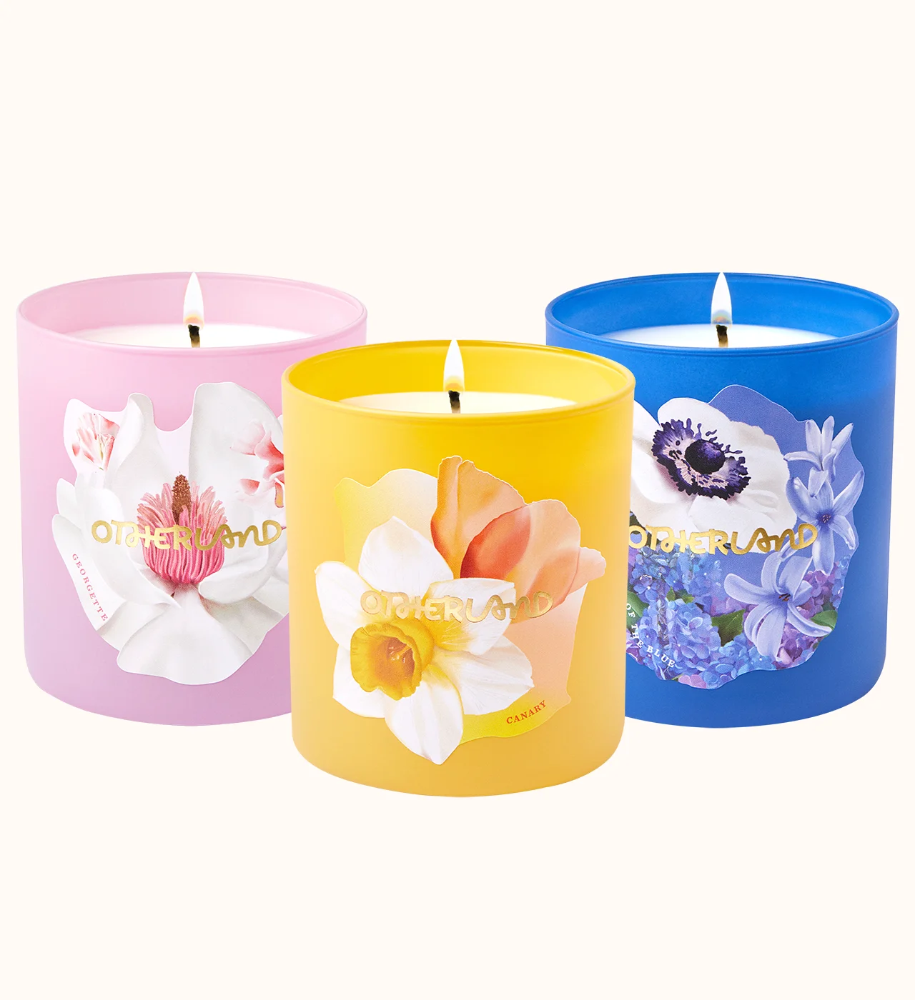 Three colorful candles with floral designs on a white background