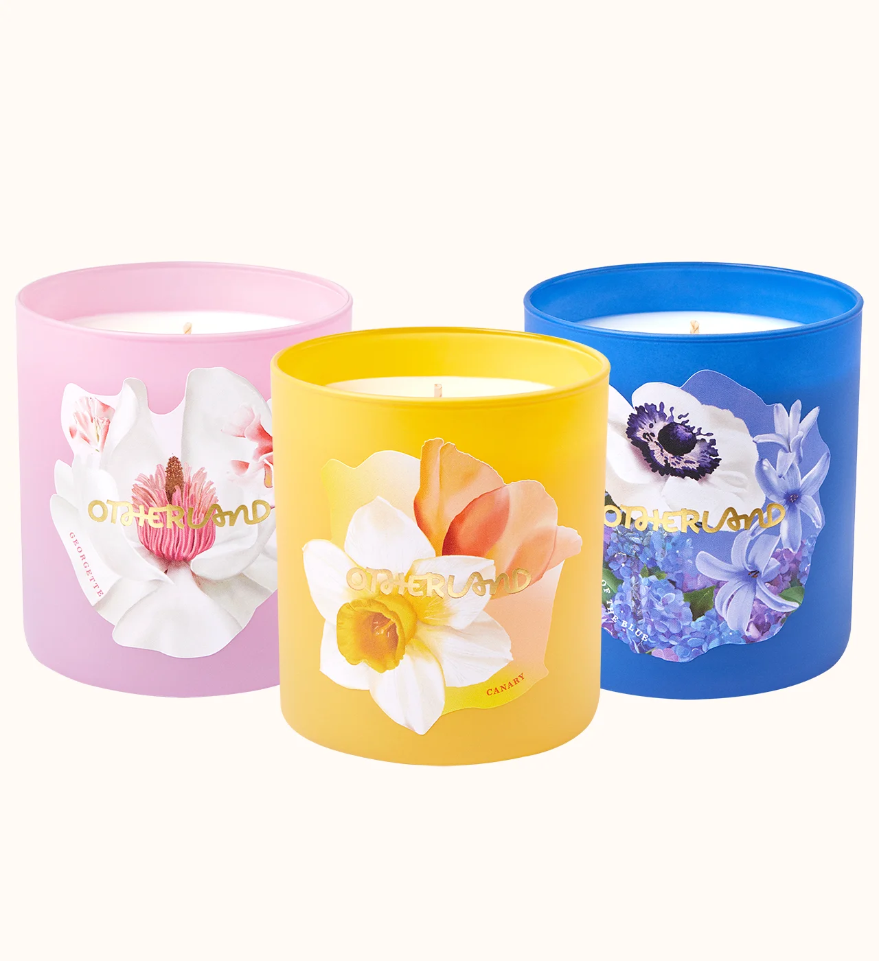 Three colorful candles with floral designs on a white background