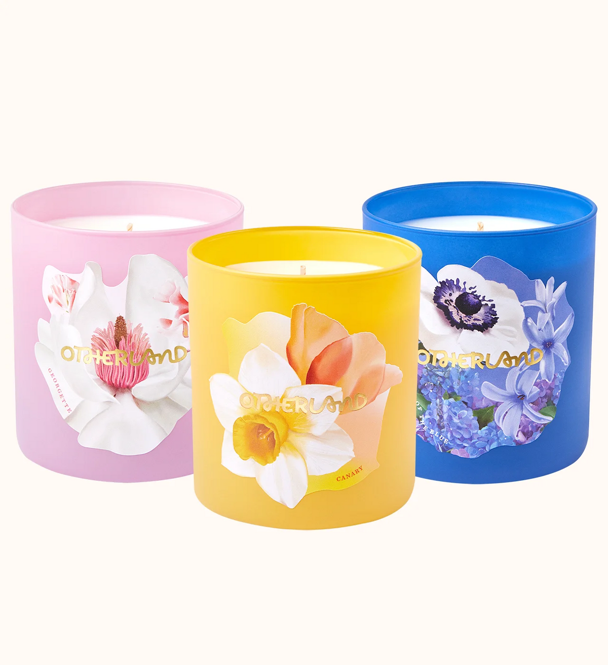 Three colorful candles with floral designs on a white background