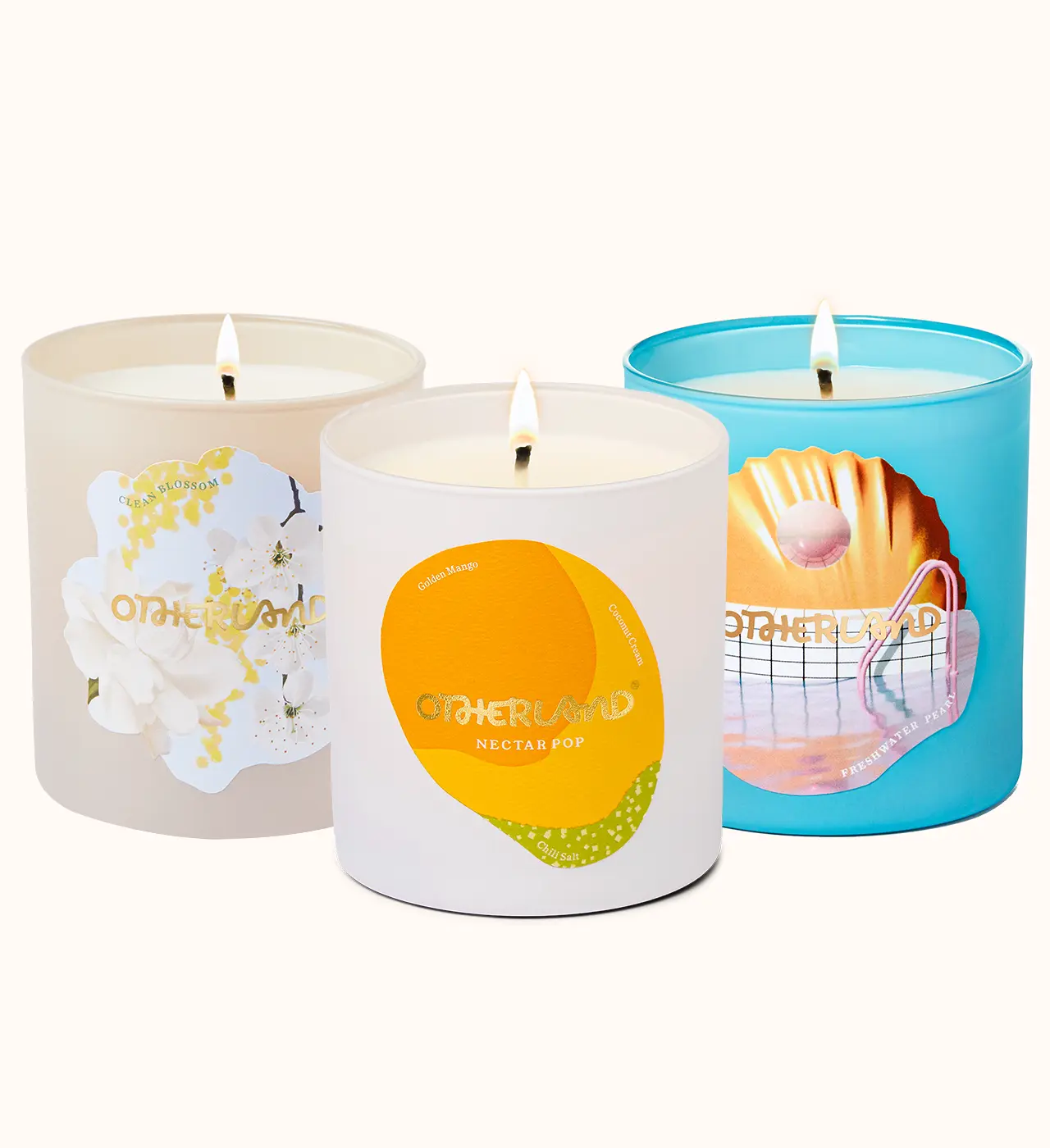 Three candles with different designs on their containers against a white background