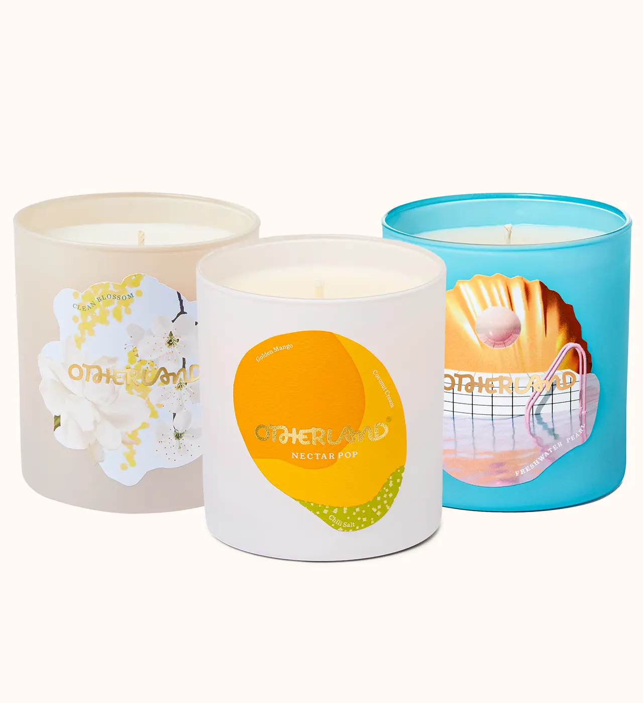 Three candles with different designs on their containers against a white background