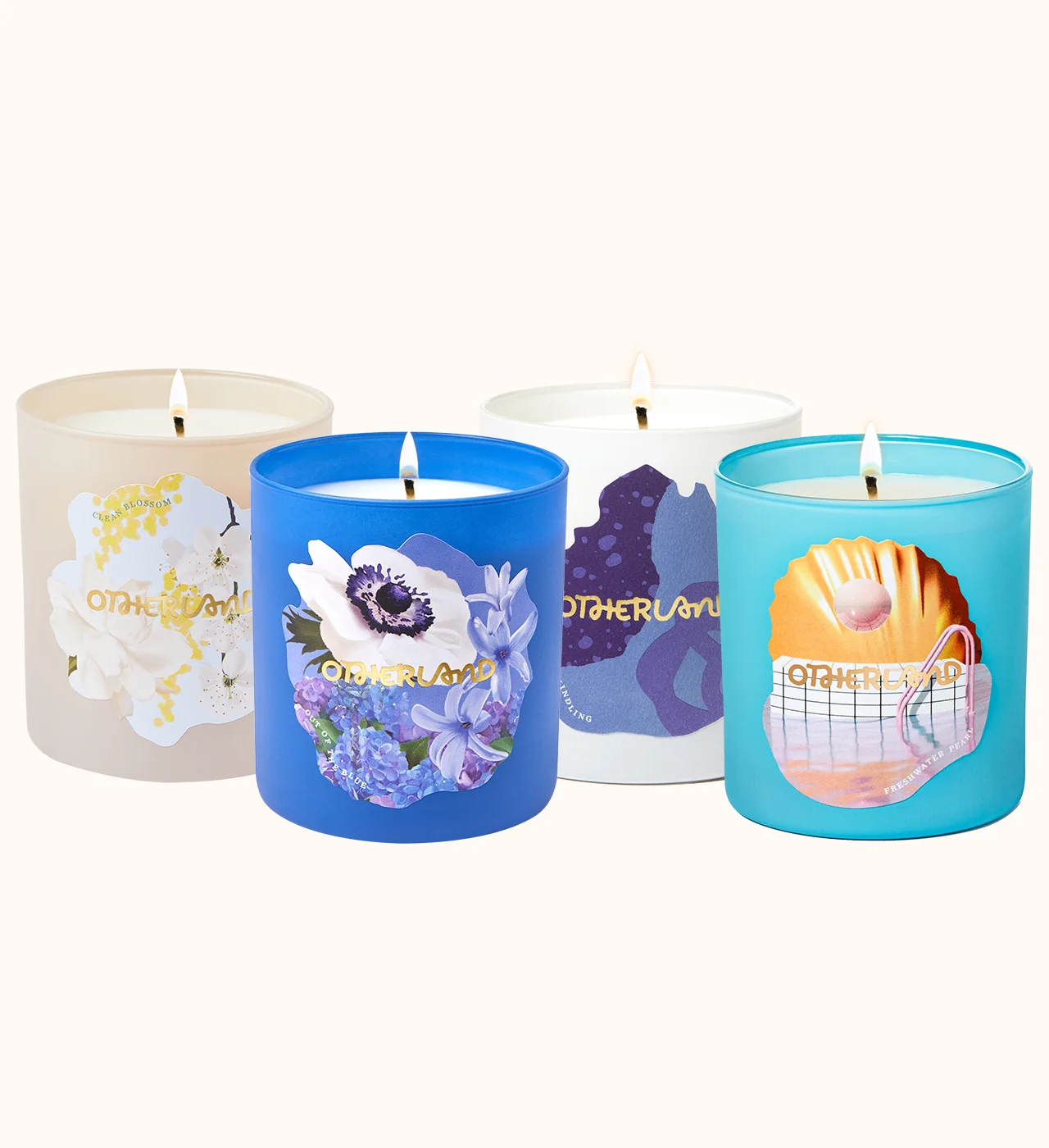 Four lit candles with colorful labels on a white background