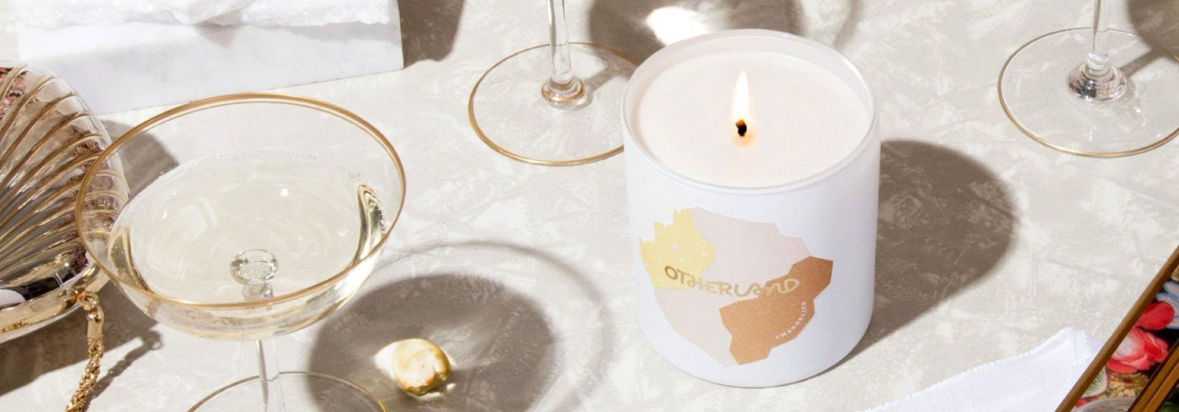 Candle on a table with glasses and decorative items