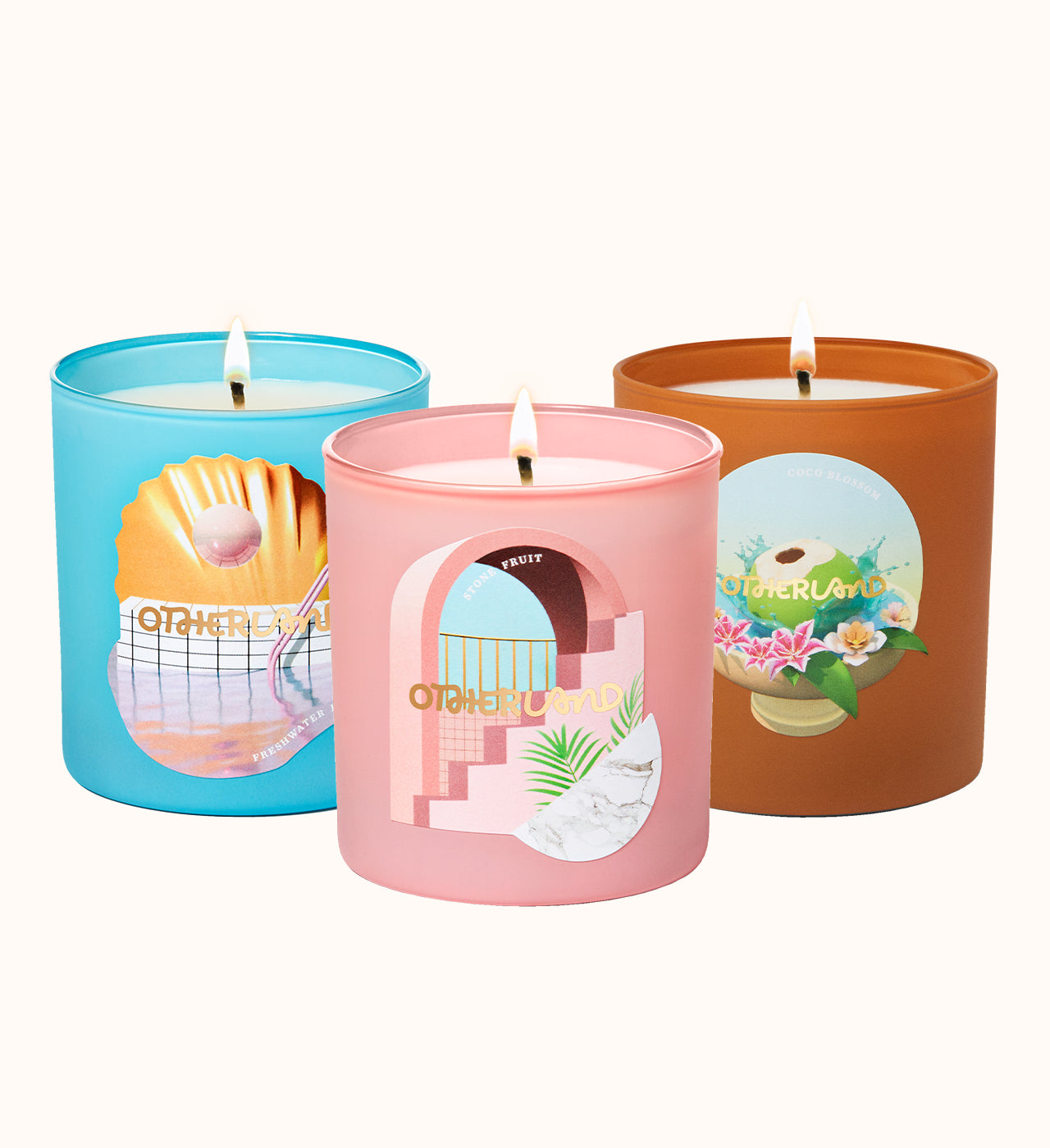 Three candles in colorful tins with artistic designs on a white background