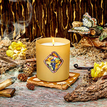 Candle with decorative label on a wooden surface with natural elements